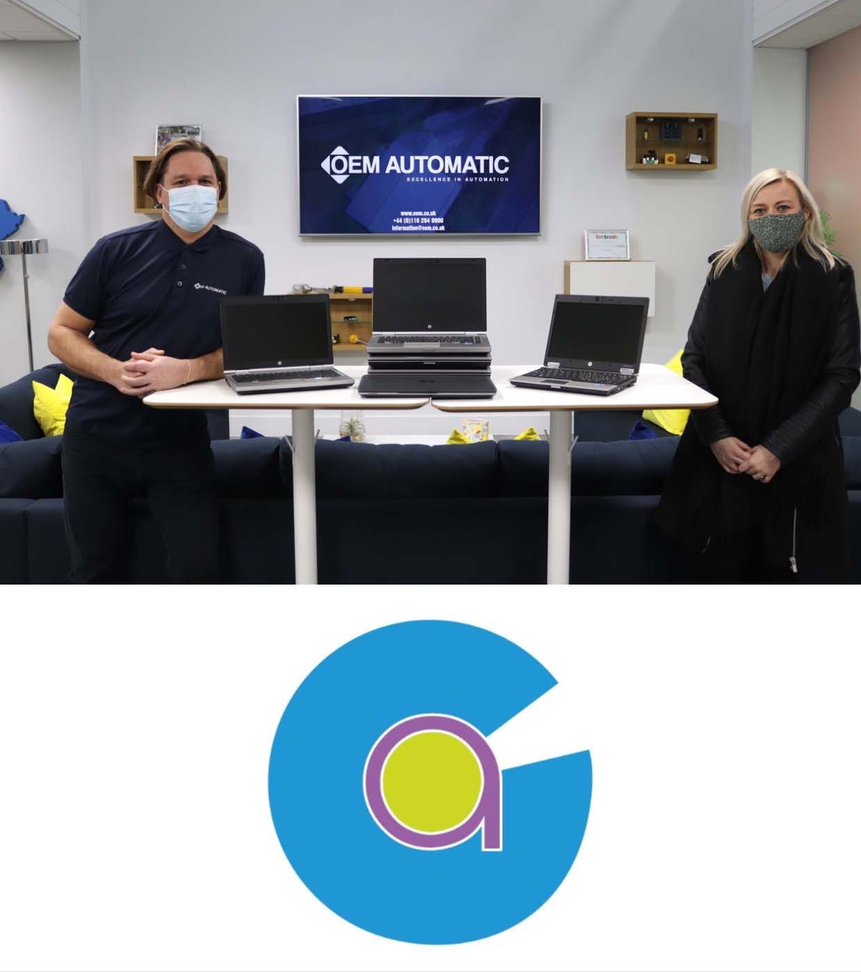 OEM Automatic's Operations Manager Adam Parkin and Countesthorpe Academy's Mrs McKenzie, OEM donating laptops