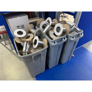 three grey bins full of waste from cable reels