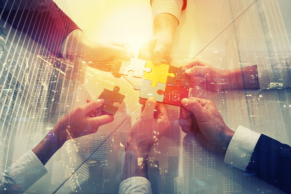 hands holding puzzle peices fitting together